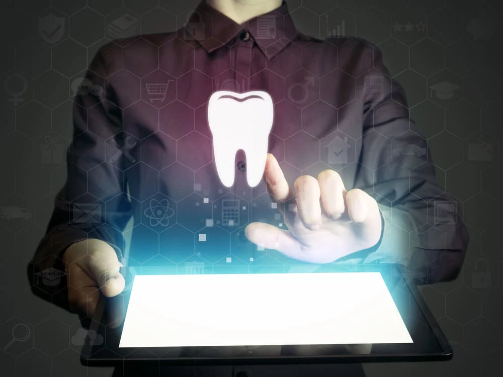 dentist digital marketing_Image of a girl with tablet pc in her hands and tooth icon. Search for dentists, dental services, consultations.