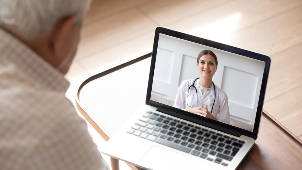 virtual consultation_Close up of modern elderly man sit at home having online consultation with doctor on computer, sick senior male talk on video call consulting with female nurse using laptop, healthcare concept