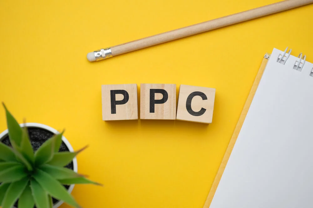 ppc effective_Modern marketing buzzword PPC - Pay per click. Top view on wooden table with blocks. Top view. Close up.