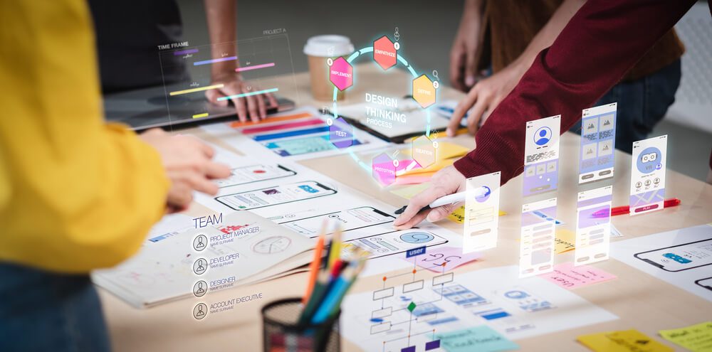 agency start-up_Close up ux developer and ui designer use augmented reality brainstorming about mobile app interface wireframe design on desk at modern office.Creative digital development agency