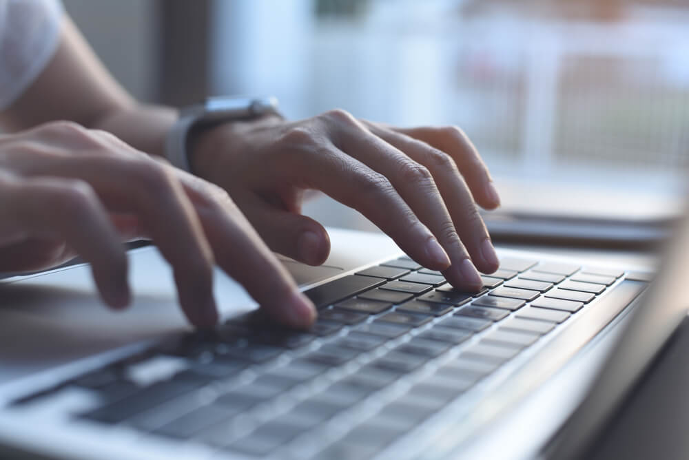 content writing_Close up image of woman hands typing on laptop computer keyboard and surfing the internet on office table, online, working, business and technology, internet network communication concept