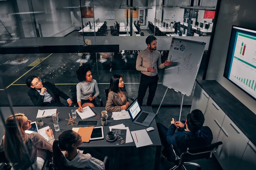 large business_Business presentation. A group of handsome business people working in a spacious conference room in a large business center. Concept of startup, projects, planning, results, strategy.