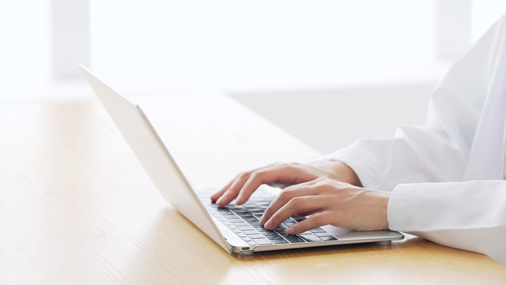 medical search engine_Woman wearing white robe working in the room