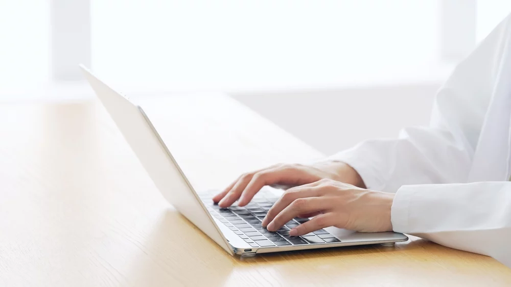 medical search engine_Woman wearing white robe working in the room