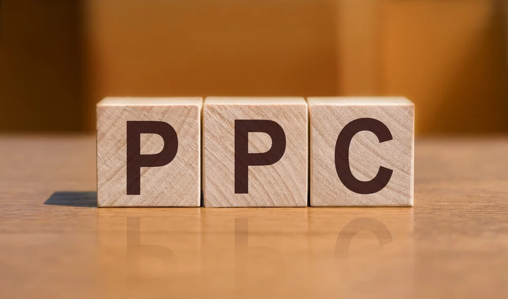 pay per click professional_PPC text on wooden cubes on orange background, business concept. PPC short for Pay Per Click_