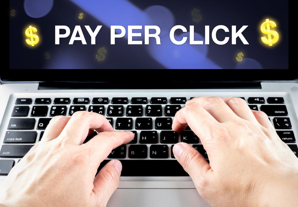 ppc management_Pay Per Click (PPC) word on notebook screen with hand type on keyboard, Digital marketing business concept