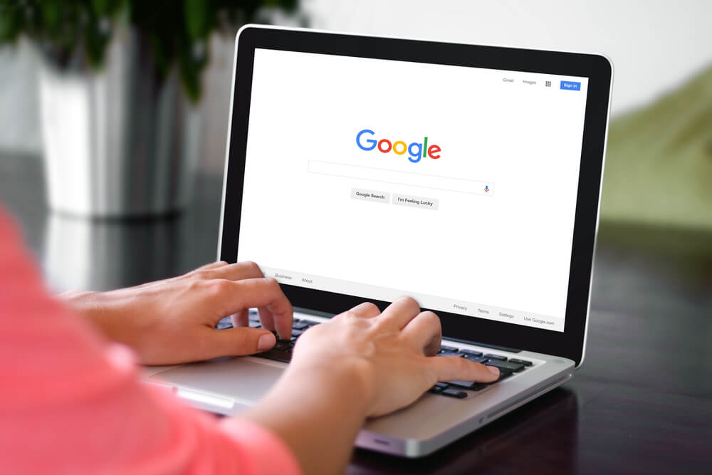 google_BEKASI, INDONESIA - NOVEMBER 29, 2015: A woman is typing on Google search engine from a laptop. Google is the biggest Internet search engine in the world.