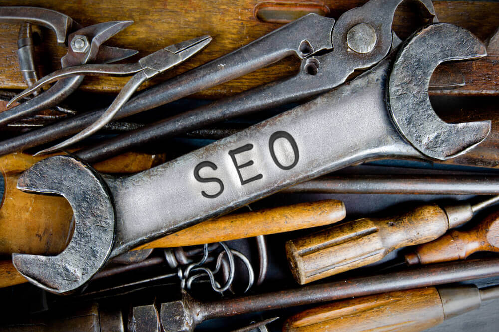 seo tools_Photo of various tools and instruments with SEO letters imprinted on a clear wrench surface