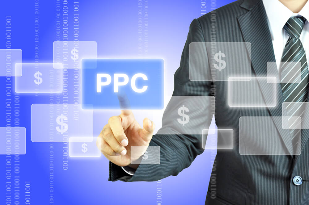 pay per click_Businessman touching PPC or Pay Per Click sign