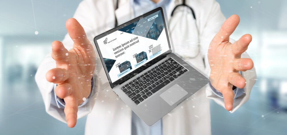 medical website_View of a Doctor holding a Laptop with business website template on the screen isolated on a background