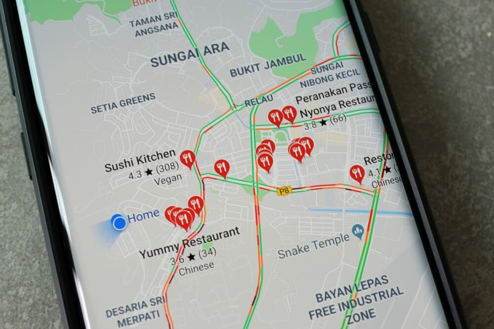 google maps_Penang, Malaysia - July 19, 2019: Smartphone with Google Maps service on the screen. Google Maps is most popular mapping service for mobile provided by Google.