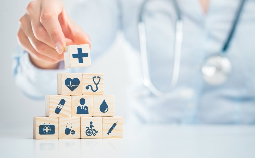 healthcare_Hand arranging wood block with healthcare medical icon. Health insurance - concept.