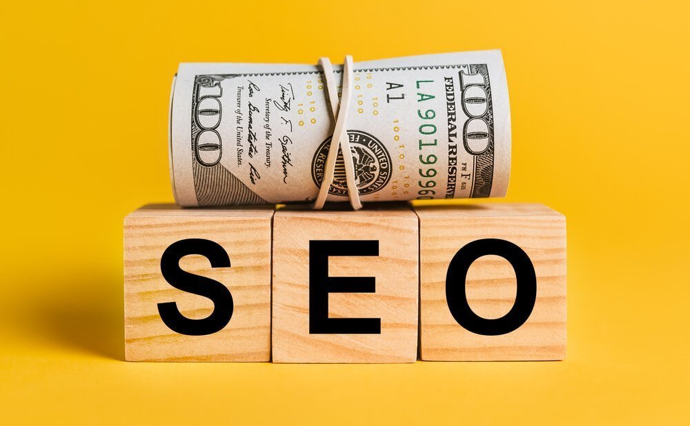 investing seo_SEO with money on a yellow background. The concept of business, finance, credit, income, savings, investments, exchange, tax