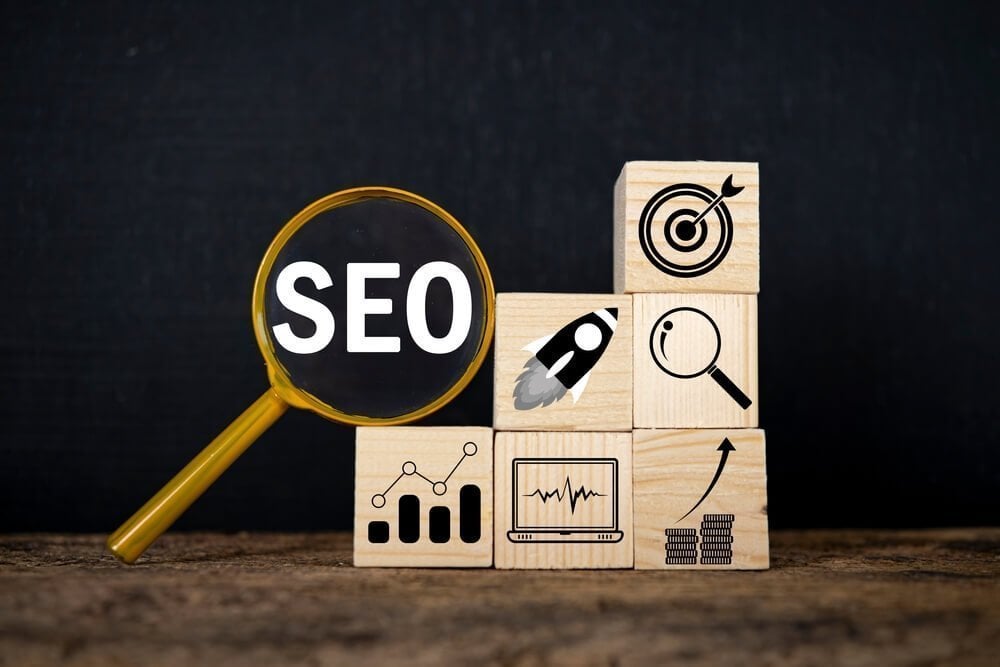 importance of seo keywords_SEO (Search Engine Optimization) text wooden cube blocks and magnifying glass on table. Idea, Strategy, advertising, marketing, Keyword and Content concept