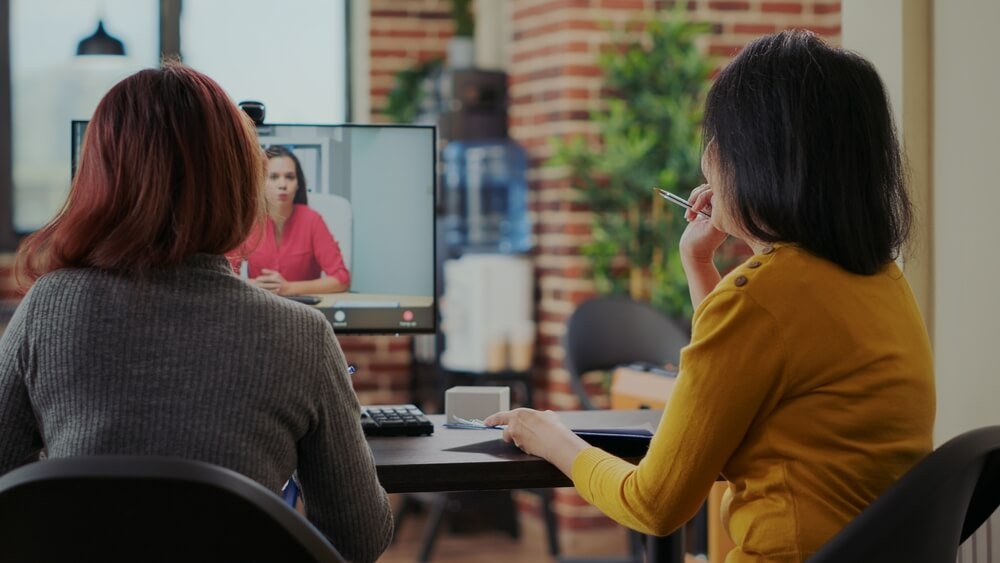 remote agency_Coworkers interviewing candidate for job application on video conference, meeting on online remote video call. Team of women talking to applicant about employment at telework interview