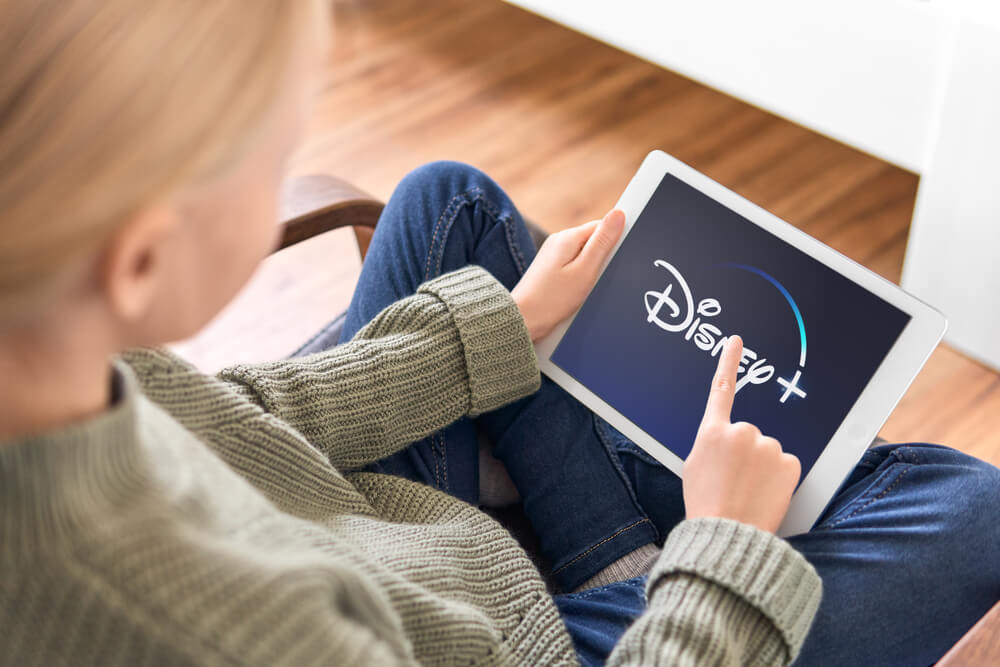 disney_January 5, 2020, Kaliningrad, Russia. Young girl holding iPad in her hands with Disney Plus application on the screen. Disney Plus is a subscription video on-demand streaming service
