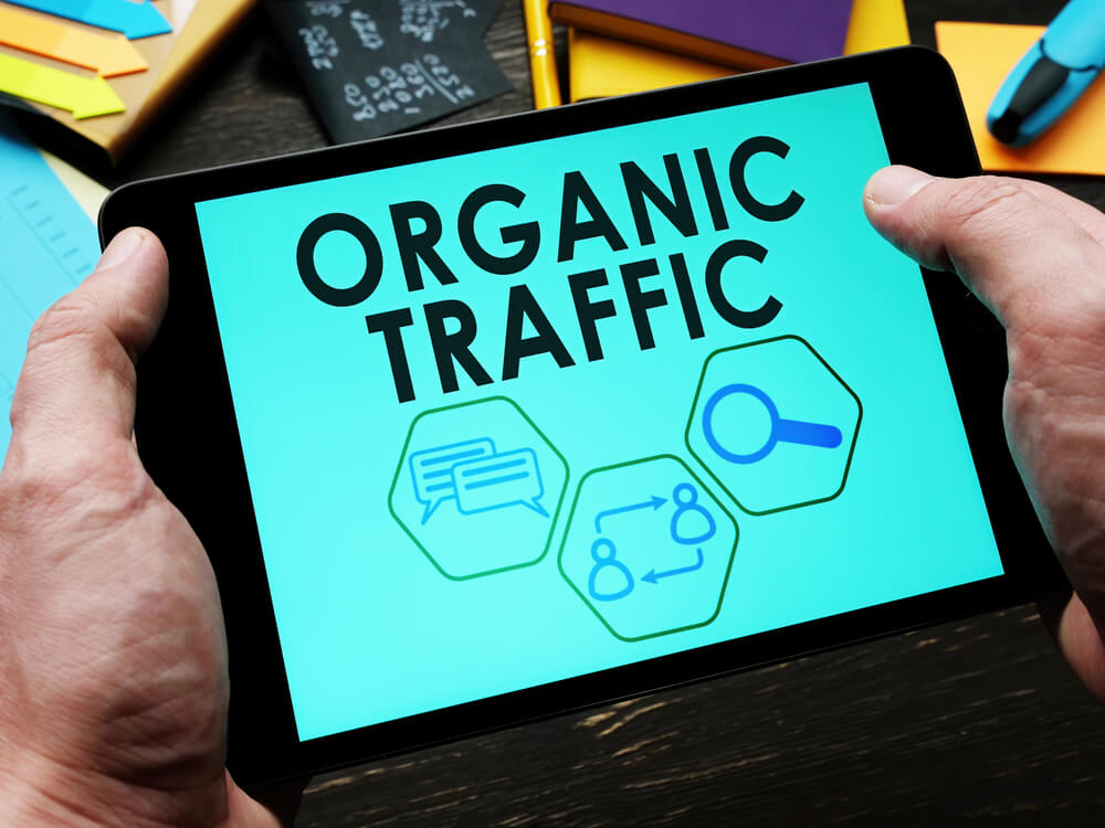 organic traffic_A man reads information about organic traffic on a tablet.