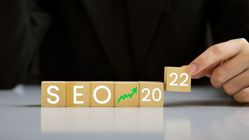 seo trends_SEO, Search Engine Optimization 2022, Hand holding wooden block represents growing business goals, Ranking traffic website internet business technology concept.