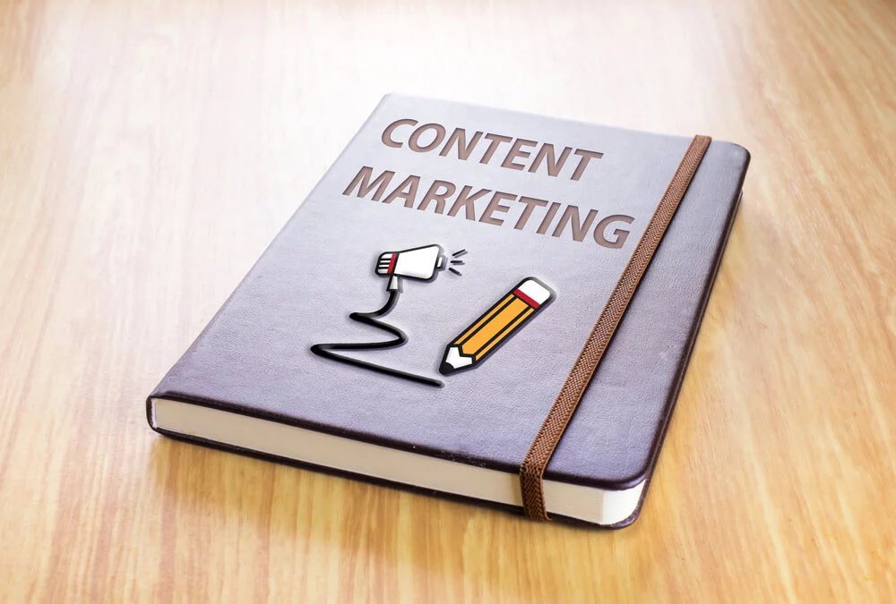 seo content marketing_Brown notebook with Content marketing word and pencil with speaker icon on wood table, Technology concept