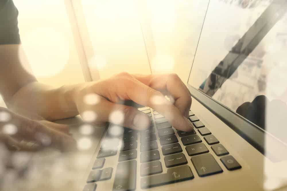 seo strategy_Close up of business man hand working on laptop computer with business strategy diagram on wooden desk as concept