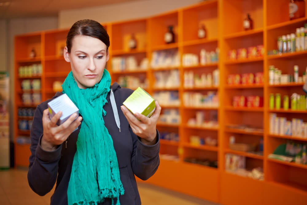 product comparison_Customer doing a price comparison in a pharmacy