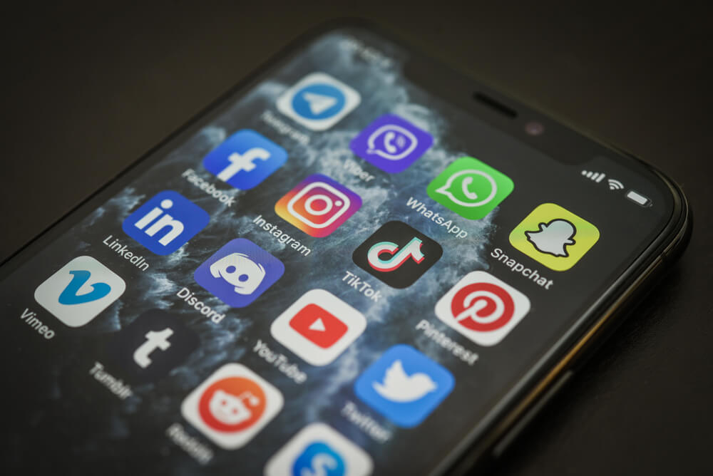 Top Strategies for Using Social Media To Boost SEO 1 social media_KIEV, UKRAINE - DECEMBER 21, 2020: Social media icons on screen of iPhone 11 Pro. Social media are most popular tool for communication, sharing information and content between people in internet.