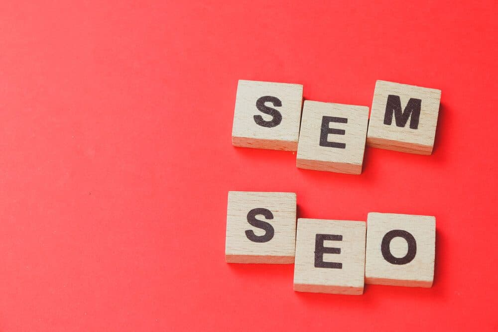 seo sem_SEM, SEO wooden block word with red background. Search Engine Marketing and Search Engine Optimization concept