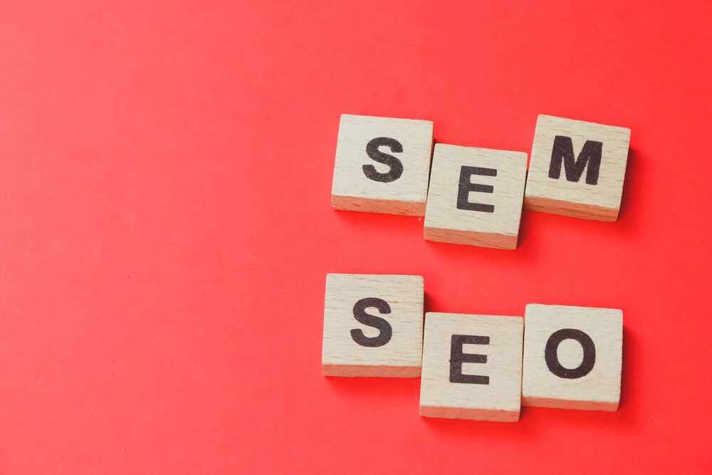 seo sem_SEM, SEO wooden block word with red background. Search Engine Marketing and Search Engine Optimization concept