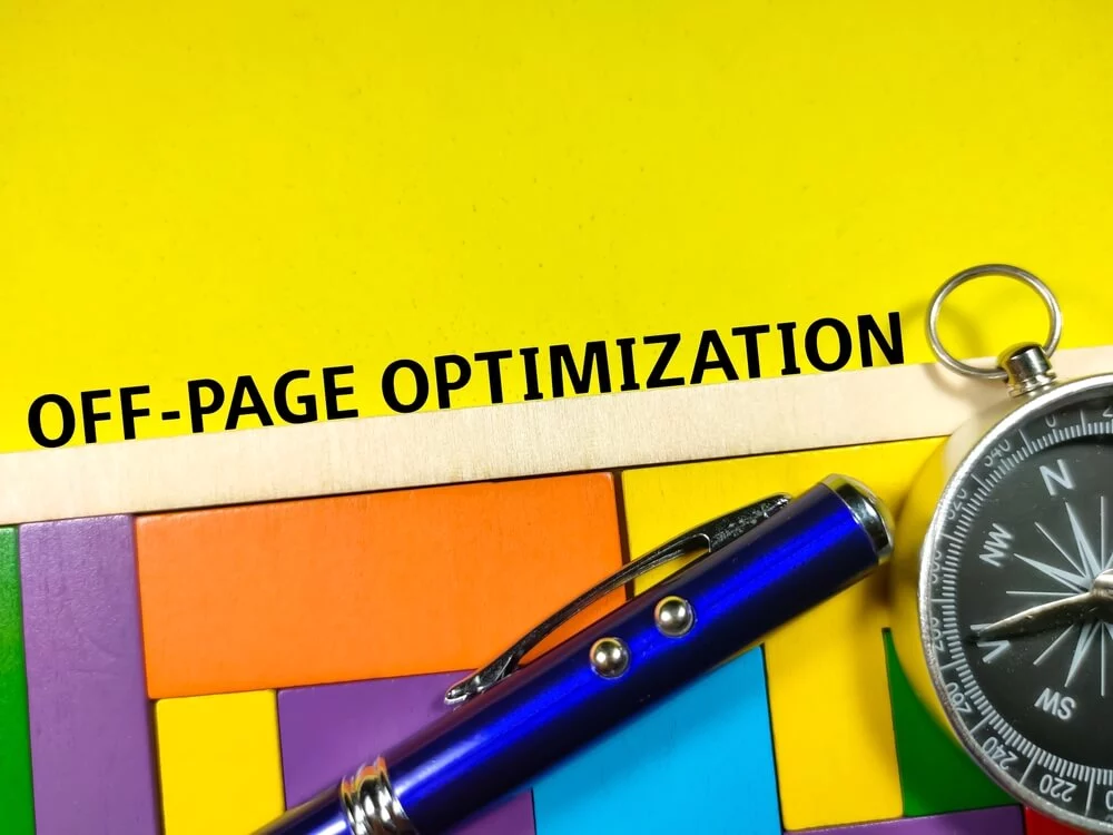 off page seo_Business concept.Text OFF PAGE OPTIMIZATION with compass,pen and wooden puzzle on yellow background.