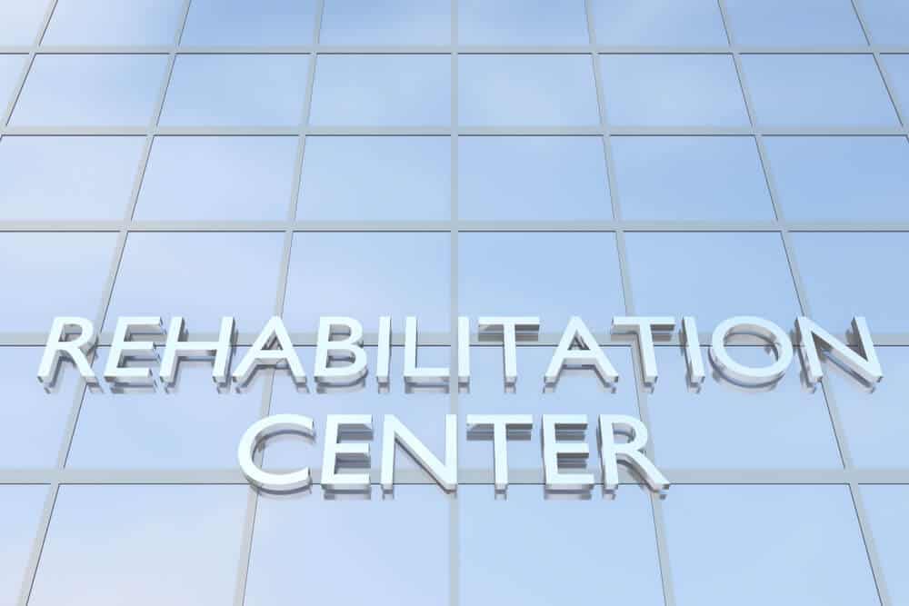 drug rehab centre_3D illustration of a building with the script REHABILITATION CENTER