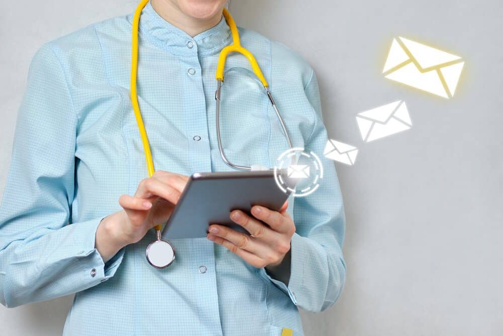 healthcare email_Abstract graphics with email and doctor holding a tablet
