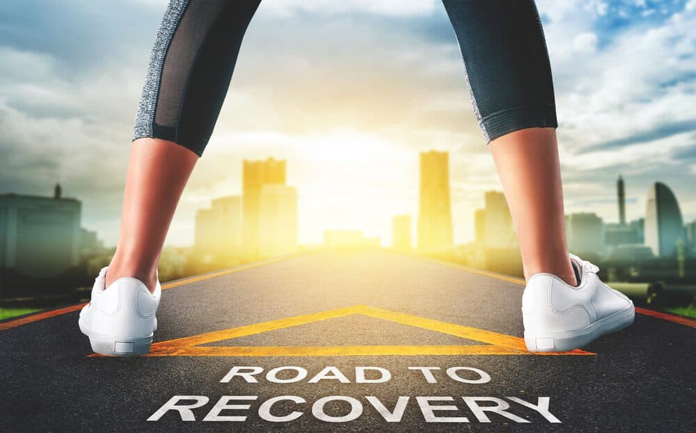 overcome drugs_Woman leg standing on Road to recovery concept for business and health concept with golden city background.