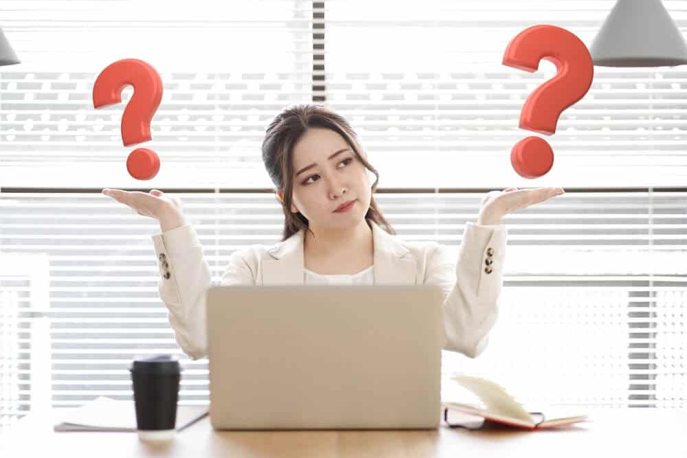 outsourcing questions_Asian women comparing question marks