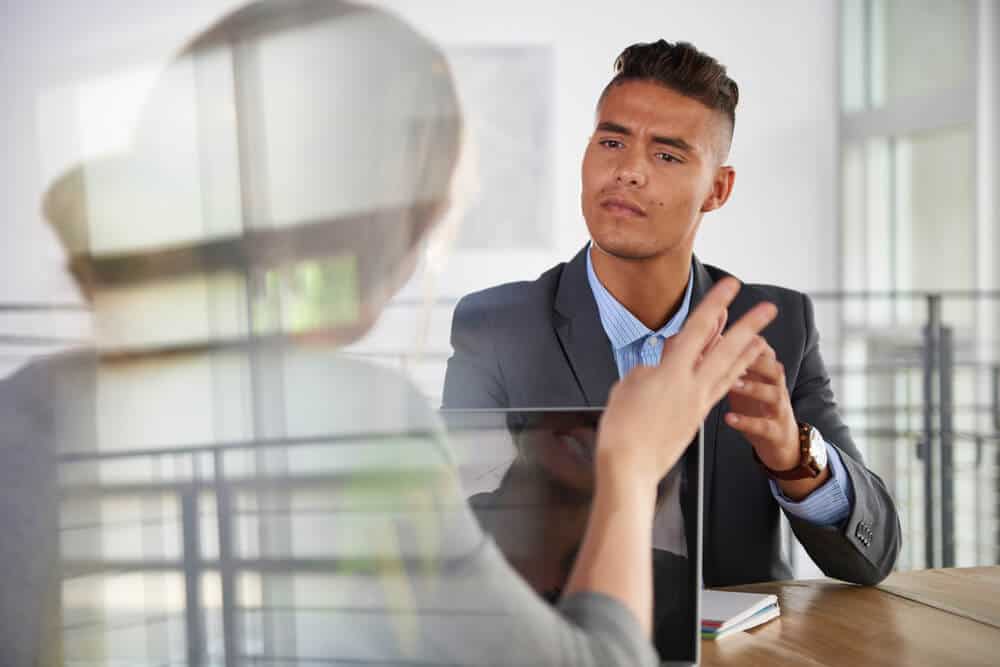 argument for hiring_team of successful business people having a meeting in executive sunlit office