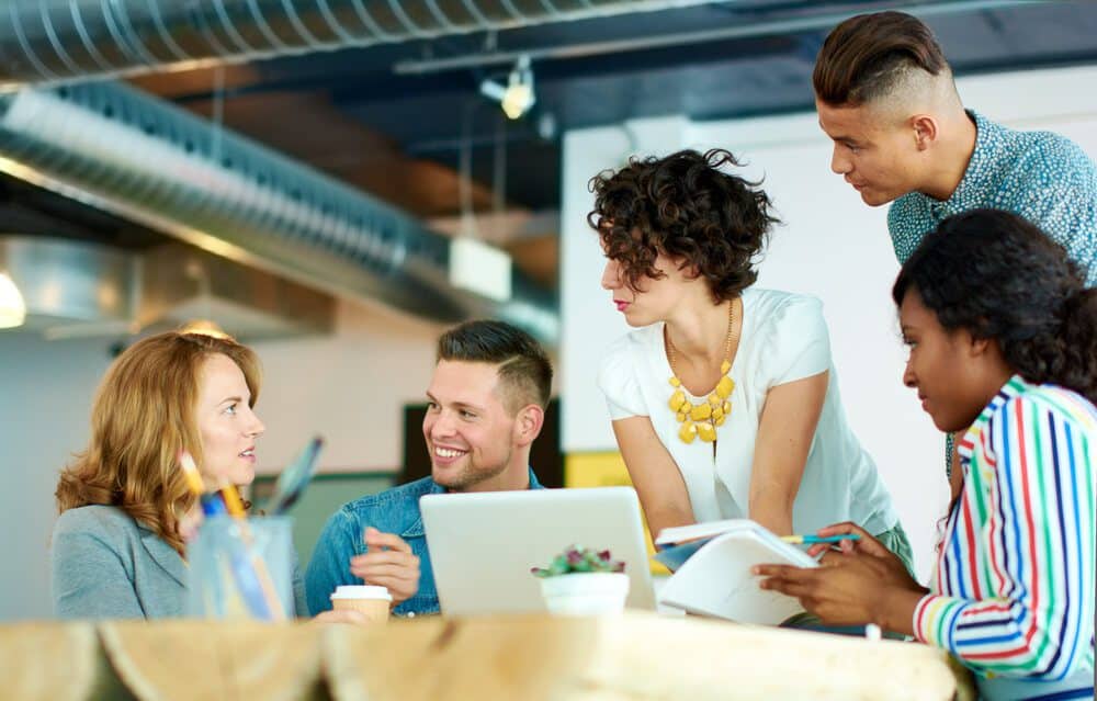 digital agency_Candid image of a group with succesful business people caught in an animated brainstorming meeting