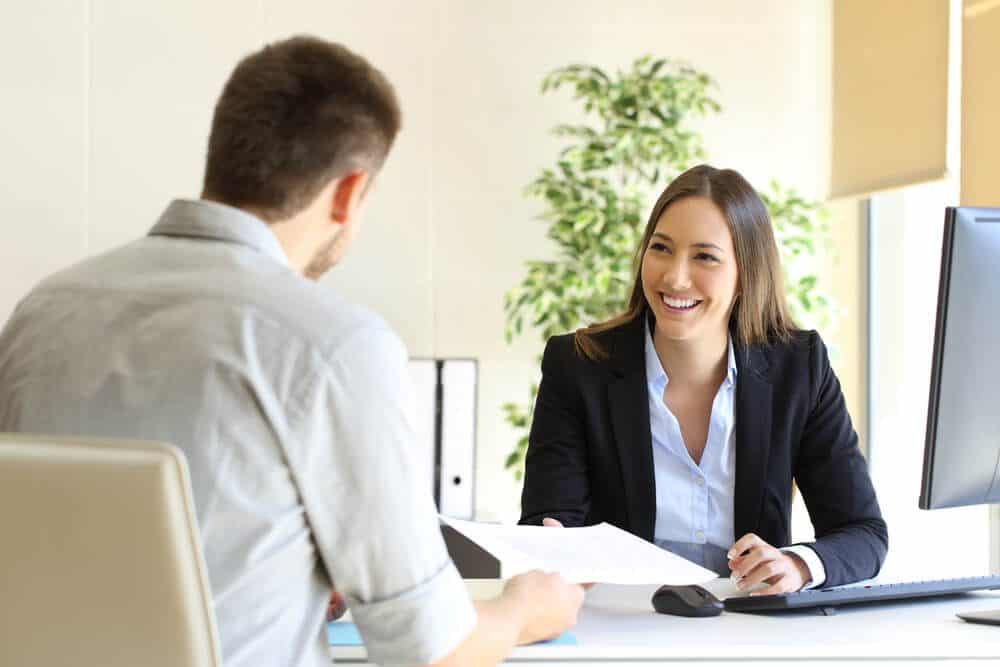 recruiting freelancer_Guy giving a curriculum vitae to his interviewer in a job interview