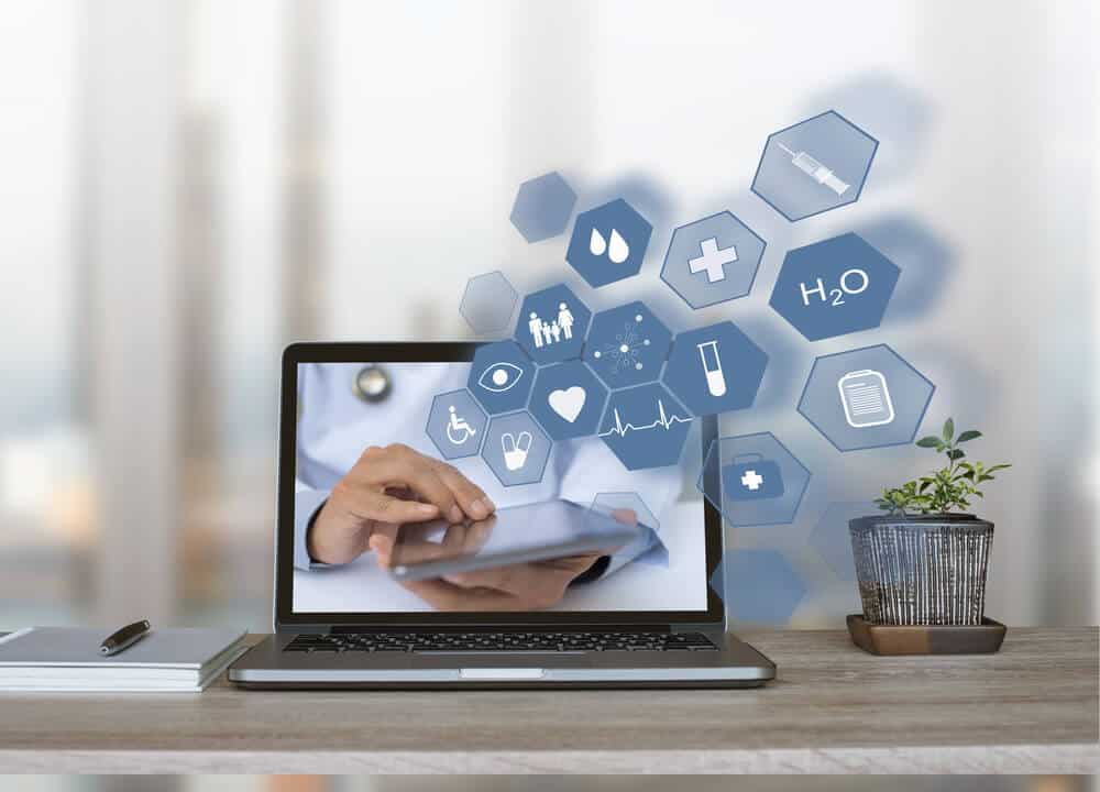 healthcare website_Doctor, consultant using digital tablet with health icons flow from home or office laptop computer on virtual screen, medical technology, e health or online service, telemedicine concept