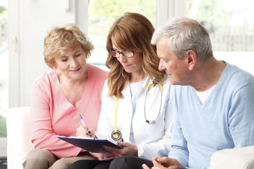 healthcare content_Female doctor consulting with senior patient at small clinic.