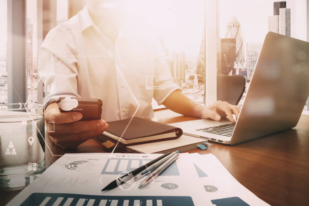 seo_businessman working with mobile phone and digital tablet and laptop computer on wooden desk in modern office with VR icon and chart diagram