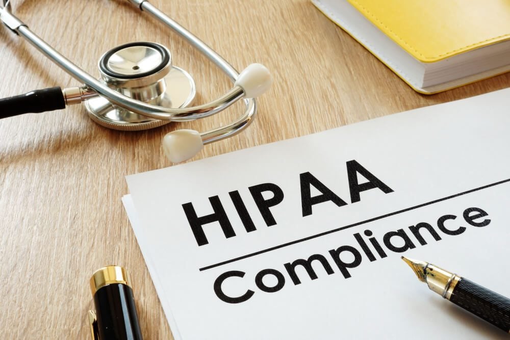 HIPAA compliant_HIPAA Compliance application and stethoscope on a desk.