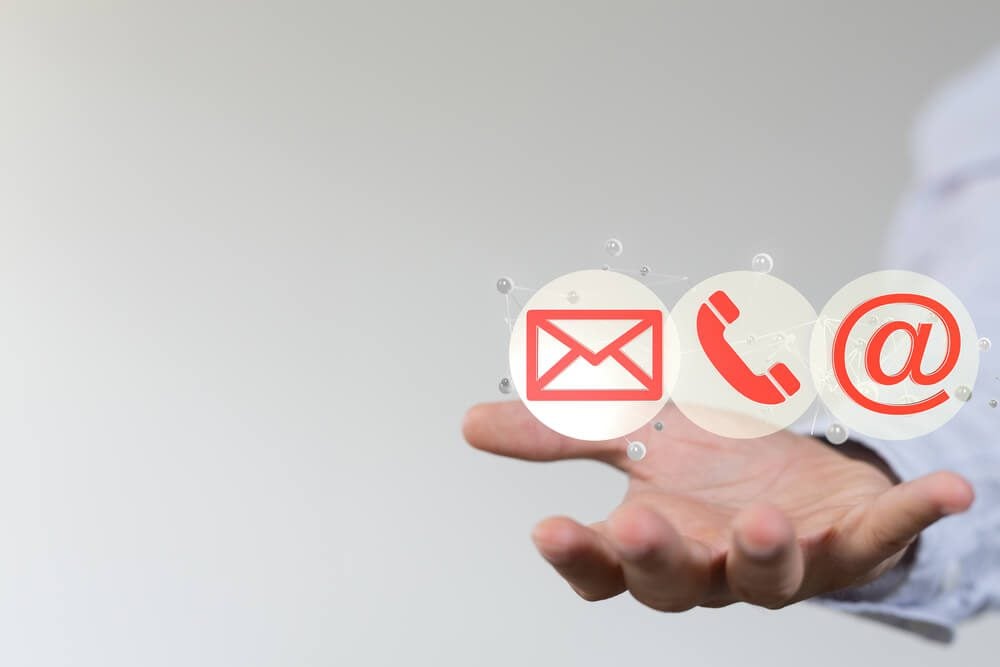 healthcare email_A man holding icons of SMS call and email