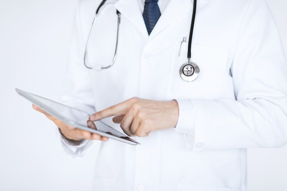 healthcare email_close up of male doctor holding tablet pc