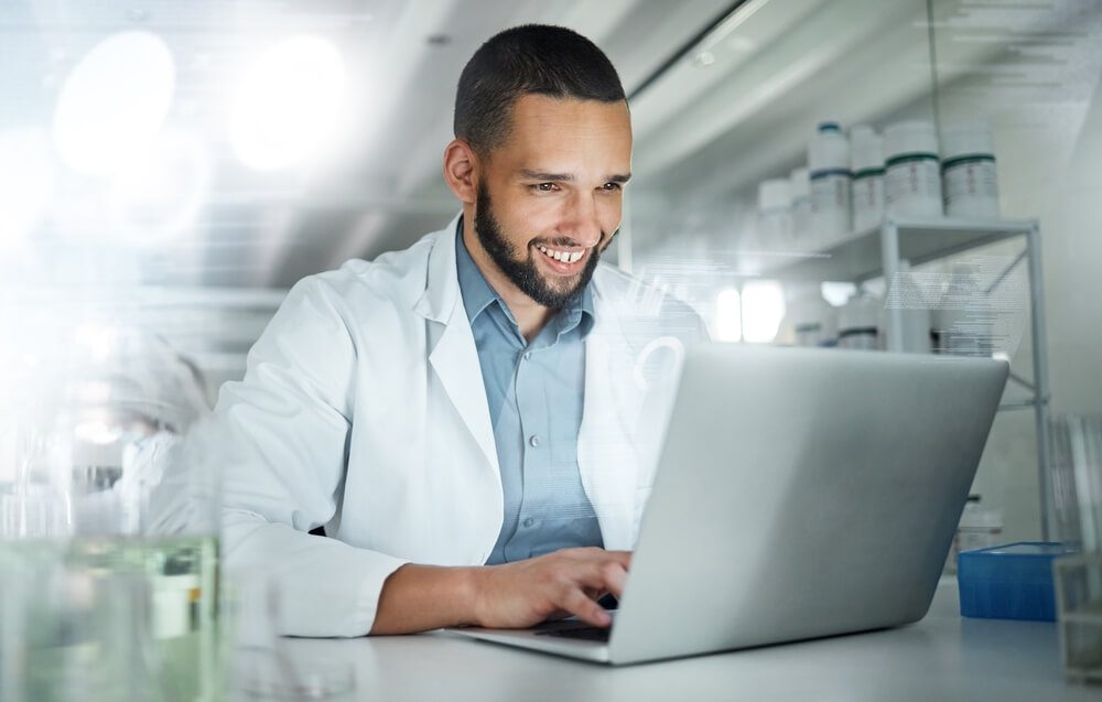 healthcare email_Science, research and laptop with man in laboratory working on analytics, pharmacy or medical. Innovation, internet and technology with scientist writing email for analysis, digital or healthcare