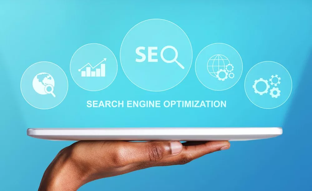 seo services_Search Engine Optimization. Black Male Hand Holding Digital Tablet With Seo Word And Seo-Optimization Tools Icons Over Blue Background. Online Business, Internet Promotion Concept. Cropped, Collage