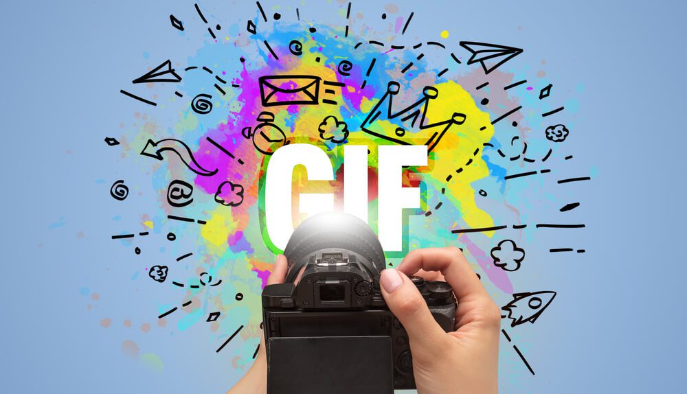 GIF_Close-up of a hand holding digital camera with abstract drawing and GIF inscription