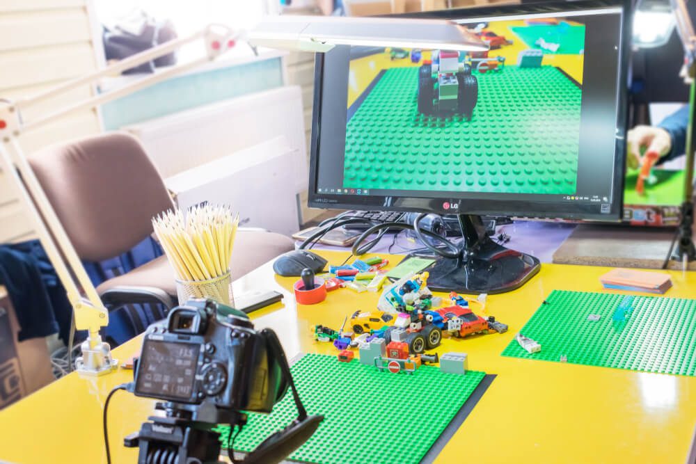 gif animated_KROPIVNITSKIY, UKRAINE – 12 MAY, 2018: Stop motion animation process with Lego details and toy cars. Computer monitor, stop motion elements to create animations using a DSLR camera on table