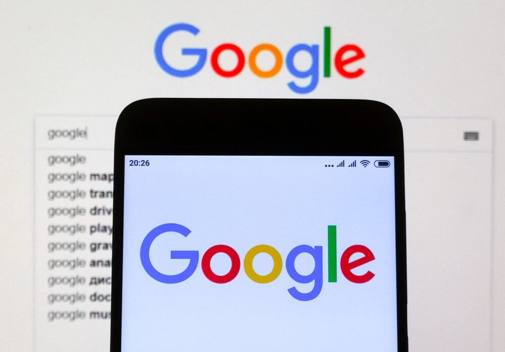 seo content_KIEV, UKRAINE - Nov. 25, 2018: Google sign seen displayed on smartphone and the laptop display.