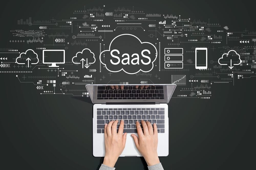 SaaS_SaaS - software as a service concept with person using a laptop computer