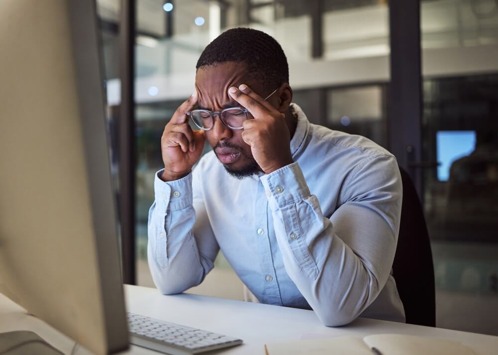 seo mistake_Stress, headache and black businessman on night office computer with 404 software glitch, cybersecurity hack and website seo mistake. Burnout, anxiety and mental health technology programmer in pain