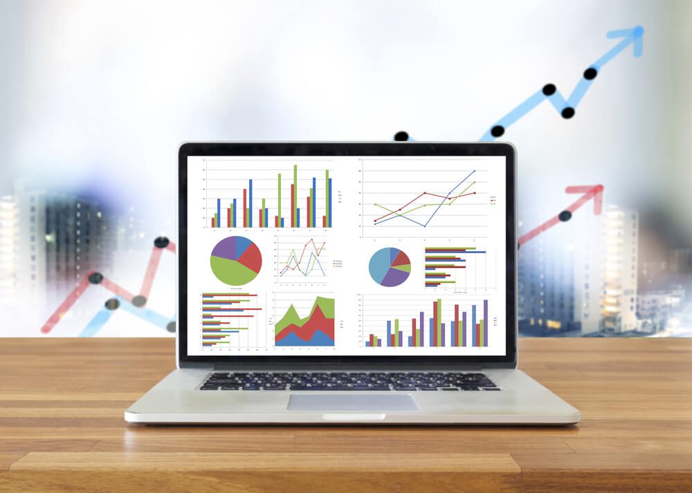 google report_Laptop on wooden table showing charts and graph, Analysis Business Accounting, Statistics Concept.